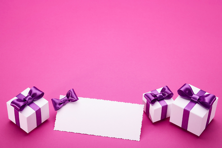 Greeting card with a satin bow, gifts in a beautiful package, for writing greetings card, several boxes of presents, festive mood attributesの写真素材