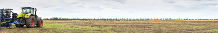 Tractor working on the farm, a modern agricultural transport, cultivation of fertile land, tractor...