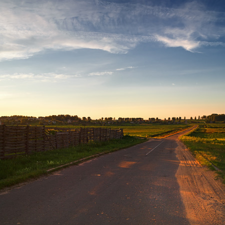 Landscape with the old asphalt road in the countryside. Evening. Square frame.の写真素材