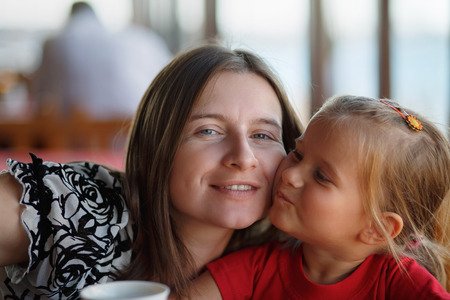 Happy mother and little daughter. Family photo closeup. Shallow depth of field. Selective focus.の写真素材
