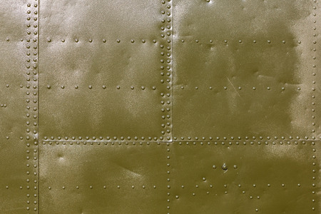 Abstract military green metal plates background texture with seams and rivets.の写真素材