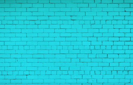 Brick wall painted in bright turquoise color. The texture of the brickwork.の写真素材