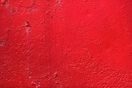 Red background. Bright painted old textured wall.の写真素材