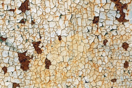 Grunge background with old peeling paint. Texture of rusty metal with cracked paint.の写真素材