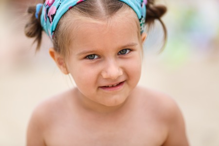 Baby girl looking at the camera. Close-up portrait of the child. Shallow depth of field. Selective focus on the eyes of the model.の写真素材