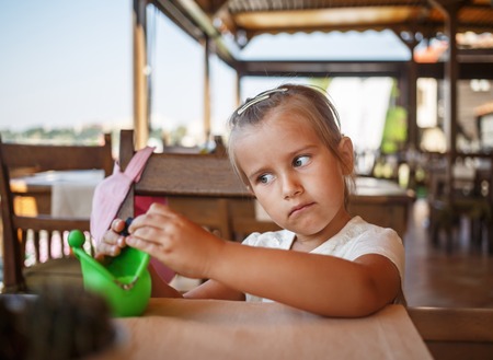 Portrait of a serious child girl. Shallow depth of field. Selective focus on child's face.の写真素材