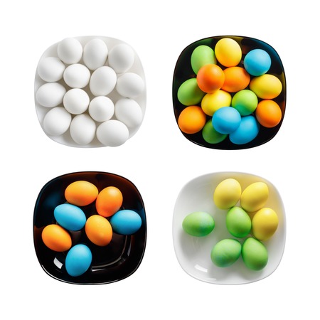 Four square plates with painted colorful Easter eggs. Colored eggs on a black and white dishes....