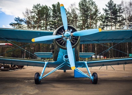 Blue airplane with propeller. Vintage biplane.の写真素材
