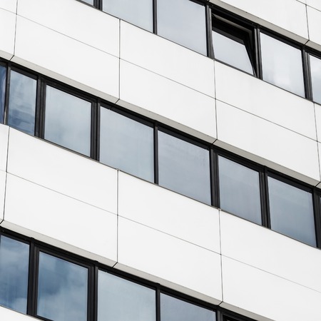 Close-up fragment of modern office building of steel and glass. Abstract modern architecture. Close-up of modern business skyscraper.の写真素材