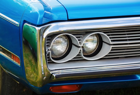 Headlights of blue retro car. Retro styled blue classic car. Selective focus.の写真素材