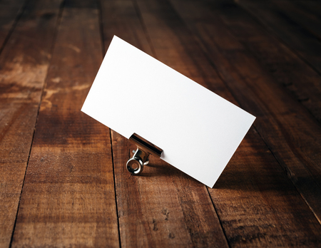 Blank business card. Photo of blank business card on vintage wood table background. Mock-up for ID. Blank template for branding identity for designers.の写真素材