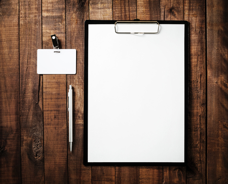 Blank branding mock-up. Blank letterhead, badge and pen. Blank ID template on vintage wooden table background. Branding template for design portfolios. Top view.の写真素材