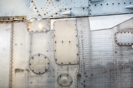 Vintage metal background. Old weathered metallic background. Vintage metal texture with rivets.の写真素材