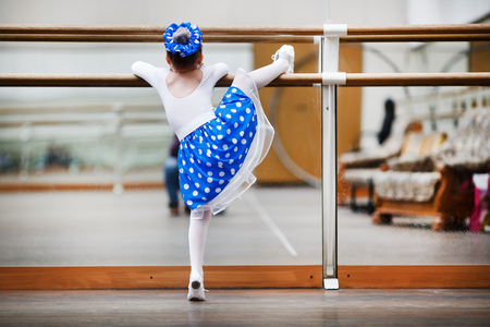 Little girl ballerina practicing in a dance class. Child girl dance. Preschool child taking dance lessons. Shallow depth of field. Selective focus.の写真素材