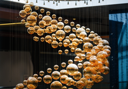 Christmas festive brilliant yellow balls in the interior. Many golden christmas balls.. Shallow depth of field. Selective focus.の写真素材