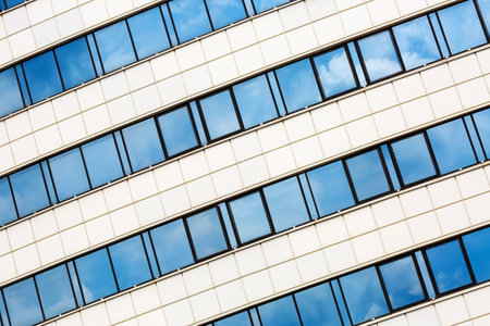 MINSK, BELARUS - MAY 03, 2016: Close-up of Minsk-Arena - a sports and entertainment complex in the city of Minsk, Belarus. Close-up of modern architecture. Reflection of blue sky with clouds in the windows.のeditorial素材