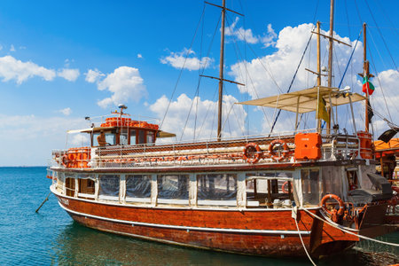 NESEBAR, BULGARIA, SEPTEMBER 06, 2013: Pleasure yacht in the port of the old town of Nessebar. Black Sea coast. Wooden passenger ship standing at the pier. Sunny summer day.のeditorial素材