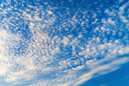 Blue sky background with white tiny cloudsの写真素材