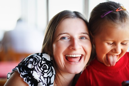 Happy mother and daughter laughing together. Funny family. Selective focus.の写真素材