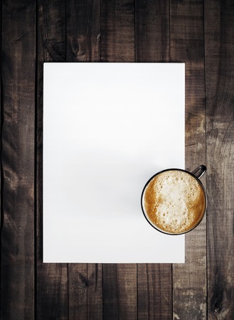 Blank letterhead and coffee cup. Template for branding identity on vintage wooden table background. Mockup for placing your design. Top view.の写真素材