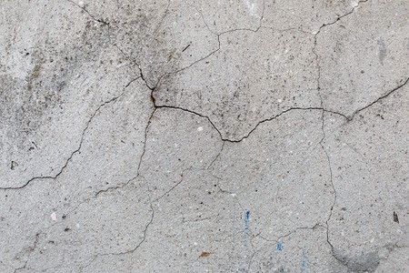Concrete wall texture with cracks. Old gray cement background.の写真素材