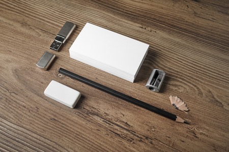 Blank stationery set. ID template. Mockup for branding identity. Bank business cards, pencil, eraser, flash drive and sharpener on wooden table background.の写真素材