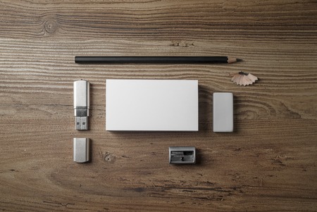 Bank business cards, pencil, eraser, flash drive and sharpener on wood table background. Photo of...