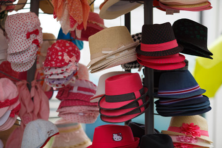 Nesebar, Bulgaria - September 02, 2014: Many variety colored hats for sale in the market. Selective focus.のeditorial素材