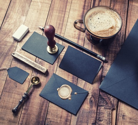 Photo of blank black vintage stationery elements on wood table background. Responsive design mockup. ID template.の写真素材