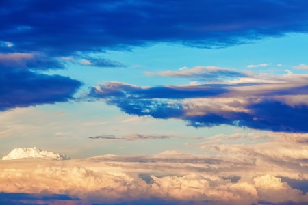 Scenic sunset sky with picturesque cumulus clouds.の写真素材