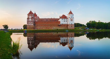 Mir, Belarus - August 11, 2016: Castle and lake. Medieval fortress in Mir, Belarus. Ancient castle with towers. UNESCO World Heritage. Panoramic viewのeditorial素材