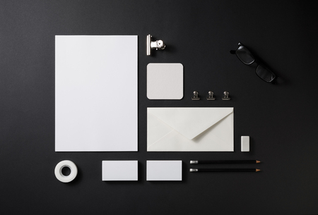 Blank stationery set on black paper background. Paperwork template. Responsive design mockup. ID template. Top view.の写真素材