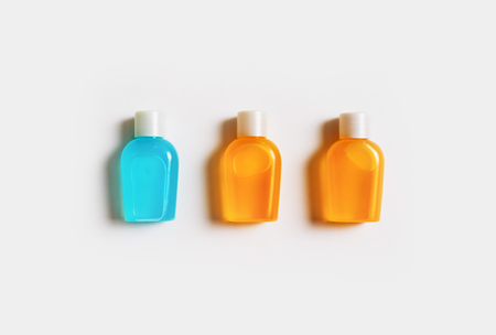 Hotel cosmetic bottles on white paper background. Set of toiletries. Flat lay.の写真素材