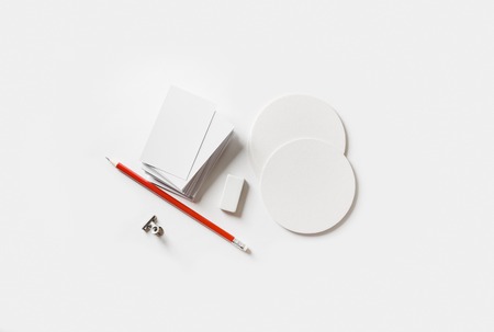 Blank stationery mockup. Blank business cards, coasters, pencil, eraser on white paper background. Template for placing your design.の写真素材