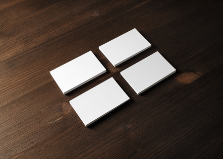 Photo of blank business cards on wooden background. Template for branding identity.