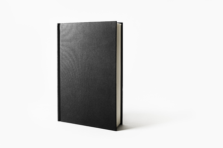 Mockup of closed blank black book on white paper background.の写真素材