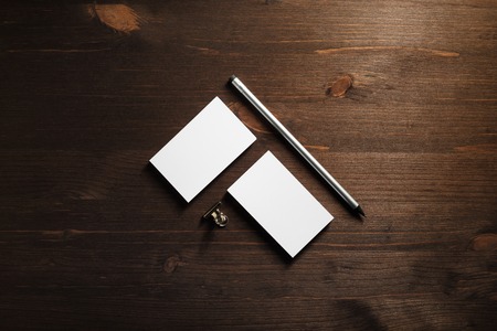 Blank business cards and pencils on wooden background. Blank stationery mockup. Objects for placing your design. Flat lay.の写真素材