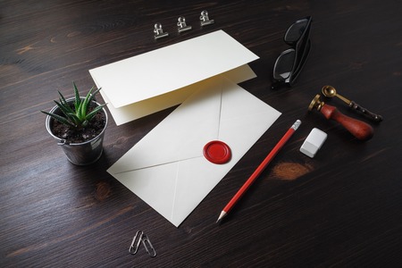 Vintage stationery and blank envelope on wooden background. Template for graphic designers portfolios.の写真素材