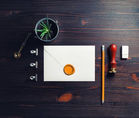 Vintage stationery and blank envelope on wood table background. Responsive design mockup. Flat lay.の写真素材