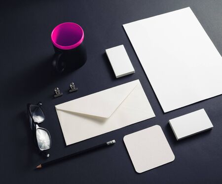 Corporate identity template. Blank stationery mock up on black paper background.