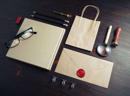 Blank branding identity set on wooden background. Kraft paper stationery template.の写真素材