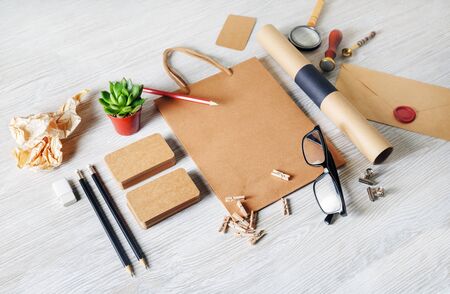 Photo of vintage kraft blank stationery set on wood background. Corporate identity template. Responsive design mockup.の写真素材