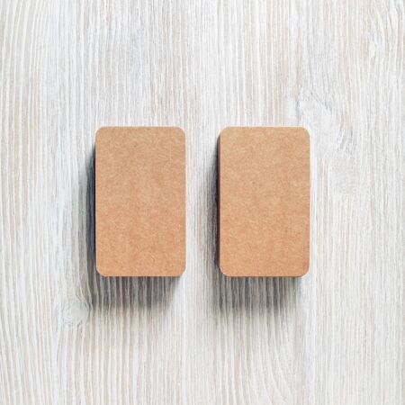 Photo of blank brown paper business cards. Template for branding identity. Flat lay.