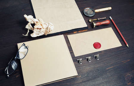 Photo of blank kraft stationery set on wooden background. Business brand template. Branding mock up.