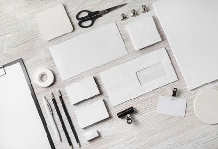 Photo of blank corporate identity. Stationery set on light wood table background. Branding mockup. Top view. Flat lay.の写真素材