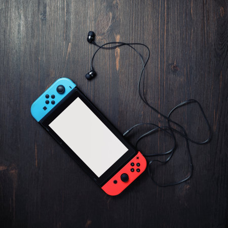 Minsk, Belarus - May 07, 2020: Nintendo Switch game console with white screen and bright joy-con...