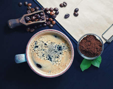 Hot coffee cup, coffee beans and ground powder. Top view. Flat lay.