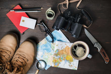 Outfit of traveler on wooden background. Tourism concept. Travel accessories and items. Top view....