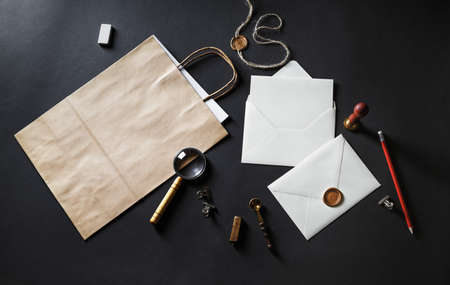 Blank retro stationery template on black paper background. Mock-up for branding ID for designers. Flat lay.の写真素材