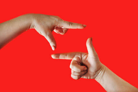 Female hands making frame on red background. Women's palms in the shape of frame.の写真素材